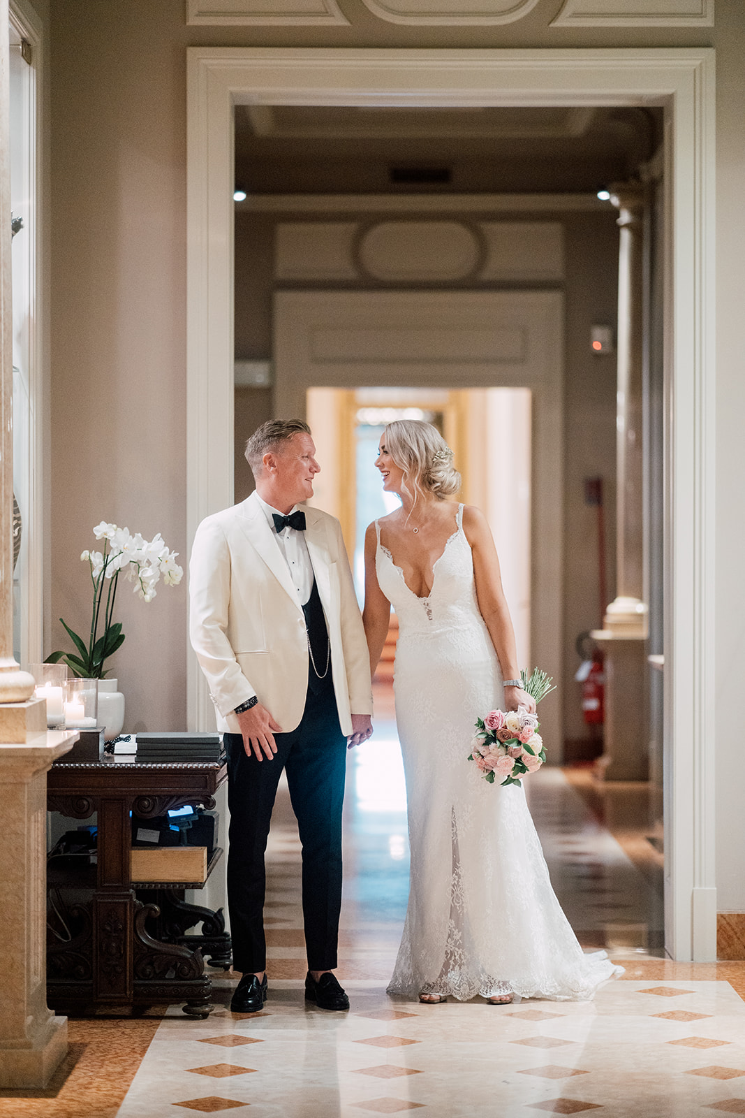 A couple sharing a smile inside their wedding venue