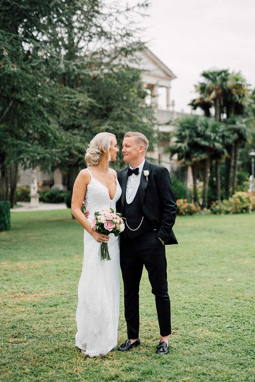 A newly married couple together in a garden